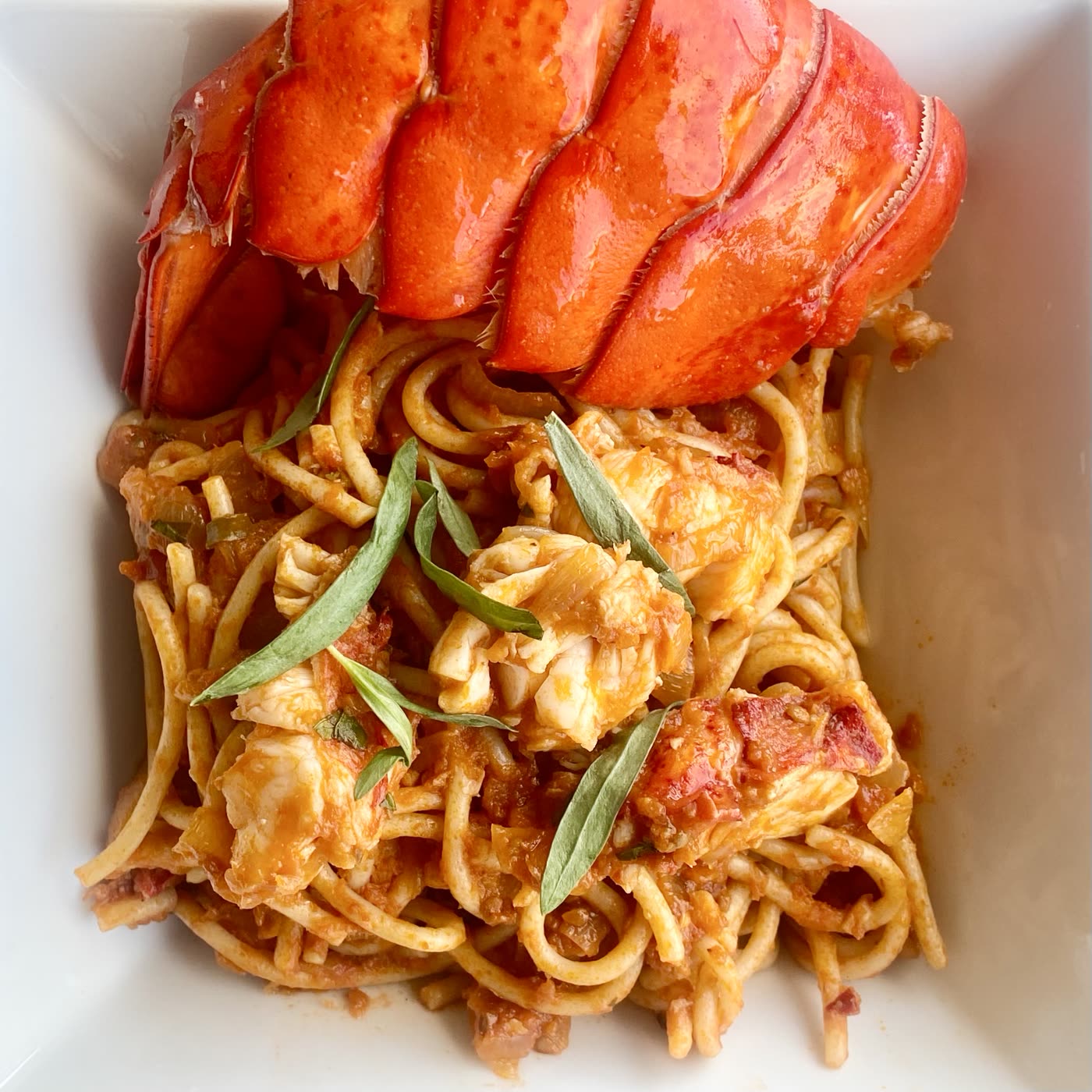 Lobster pasta in light tomato cream sauce with basil, with a keto zucchini noodle alternative